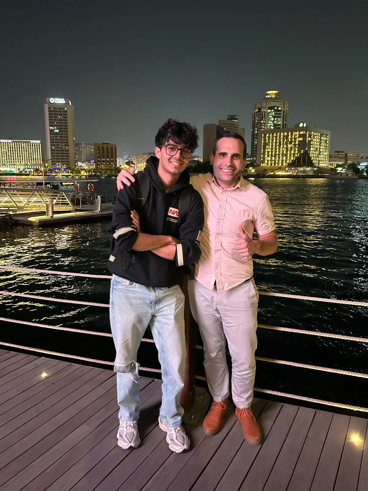 Two teammates on the Dubai waterfront at night