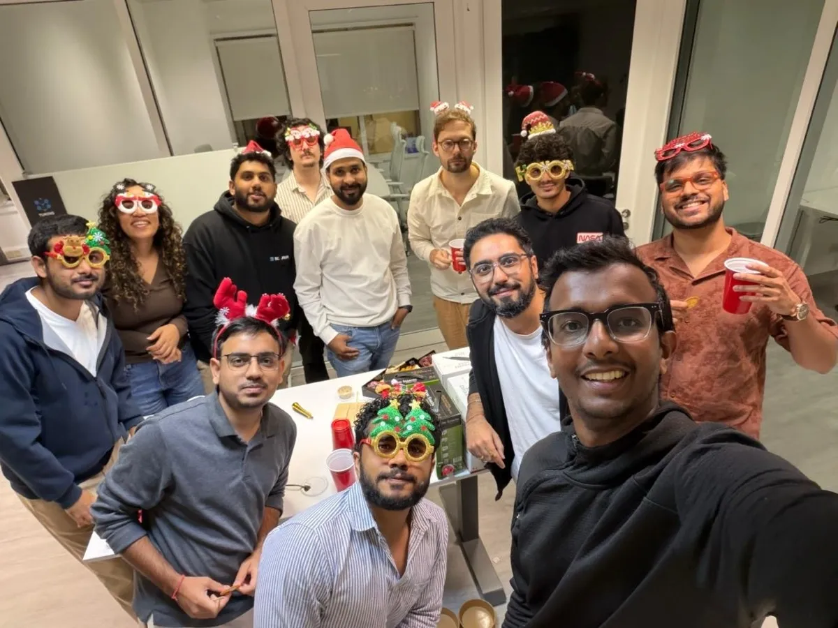 Holiday party selfie with festive glasses and Santa hats