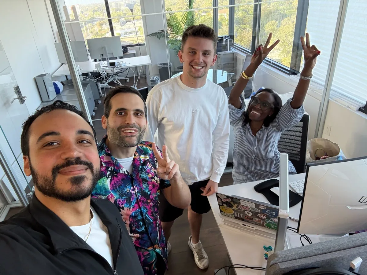 Team selfie in the office with peace signs